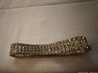 Full view of rhinestone stretch bracelet on fabric background