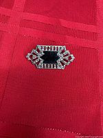 Front view of brooch showing central black stone and surrounding marcasite