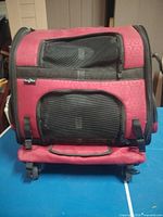 Front view showing mesh windows, red fabric, wheels