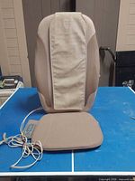 Front view of Homedics massage cushion with seat pad and remote