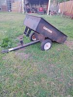 Side view of Craftsman steel dump cart showing body, hitch tongue, one wheel