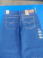 Back view of Levi's pinstriped jeans showing pockets and attached tags