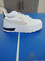 Side view of right shoe showing upper, platform sole and branding