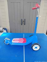 Full view of blue three-wheel Radio Flyer scooter