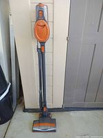 Full view of Shark Rocket stick vacuum standing upright
