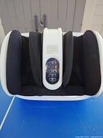 Top view of foot massager showing three foot wells and control panel