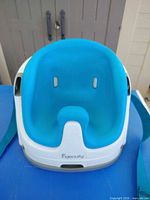 Front view showing blue foam insert in white booster seat