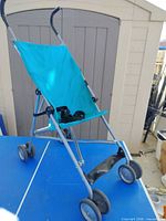 stroller fully open showing seat, frame, wheels, handles