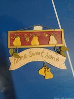 Front view of wall decor showing pears and banner