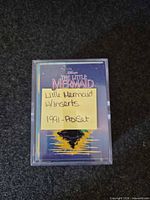 Front view of plastic case with sticky note identifying Little Mermaid set