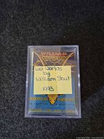 front view of card set inside clear plastic box with title card