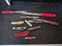 All nine knives laid out showing variety and scale