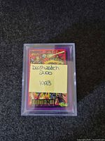 cards in case with sticky note label showing title and year