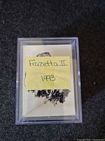 Front of plastic case with handwritten label over top card