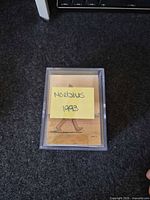 Front view of plastic case with stack of cards, sticky note labelled Moebius 1993