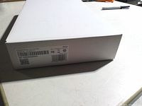 Box corner with product label showing Product Name: Touchscreen, color White, barcode