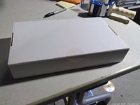 Closed white retail box containing ADT touchscreen