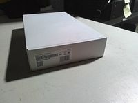 Closed plain white box showing barcode, QR code, FCC label identifying ADT touchscreen panel