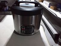 Front view of Aroma stainless steel slow cooker showing digital control panel