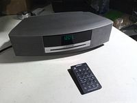 Front view of Bose Wave music system showing display and remote