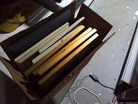 Box containing assorted frames viewed from above