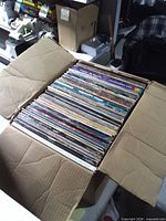 Closed box opened showing full stack of LP records