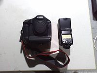 Front view of Canon EOS-1 body beside Canon 580EX flash