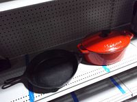 Dutch oven and skillet side by side on shelf