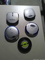 Top view of five portable CD players showing fronts and controls