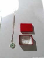Necklace laid out beside open box