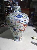 Front view of lidded wucai porcelain dragon vase
