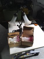 Lamp with two white/pink shades plus boxes containing spare shades