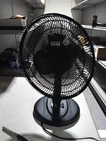 Front view of Comfort Zone table fan showing grille and base