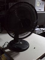 Front view of black Comfort Zone fan showing grille and base
