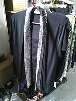 Front view of black top displaying sequin lapels