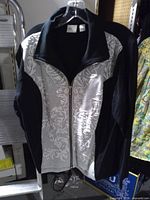 Front view of Chico's Zenergy zip-up jacket on hanger