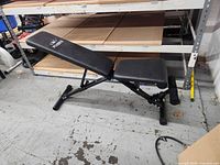 Full view of Flybird adjustable workout bench showing frame, seat, backrest and leg rollers