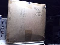 Front of sealed box showing handwritten label Halyard Gown 41737NS