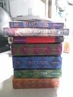 Stack of seven Harry Potter paperback books showing spines and titles