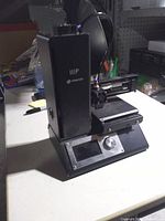 Front angled view showing IIIP branding, LCD screen, build plate and extruder