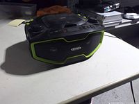 Front angled view showing Jensen branding, speaker grilles and lime-green trim