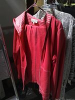 Front view of red Jones New York hoodie jacket on hanger