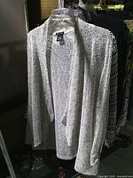 Front view of open-front cardigan on hanger