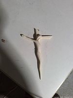 Front of crucifix showing stylized corpus