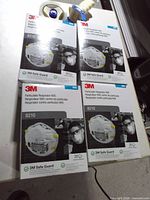 Front view showing four sealed boxes of 3M 8210 respirators