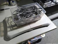Wii Balance Board with plastic tub containing cables