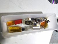 Top view of eight assorted perfume bottles in white tray