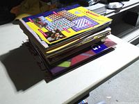 Side view of stacked quilting books and magazines