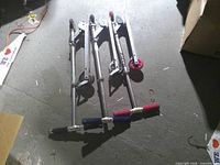 Three Razor scooters unfolded on floor