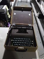 Typewriter in open tweed case